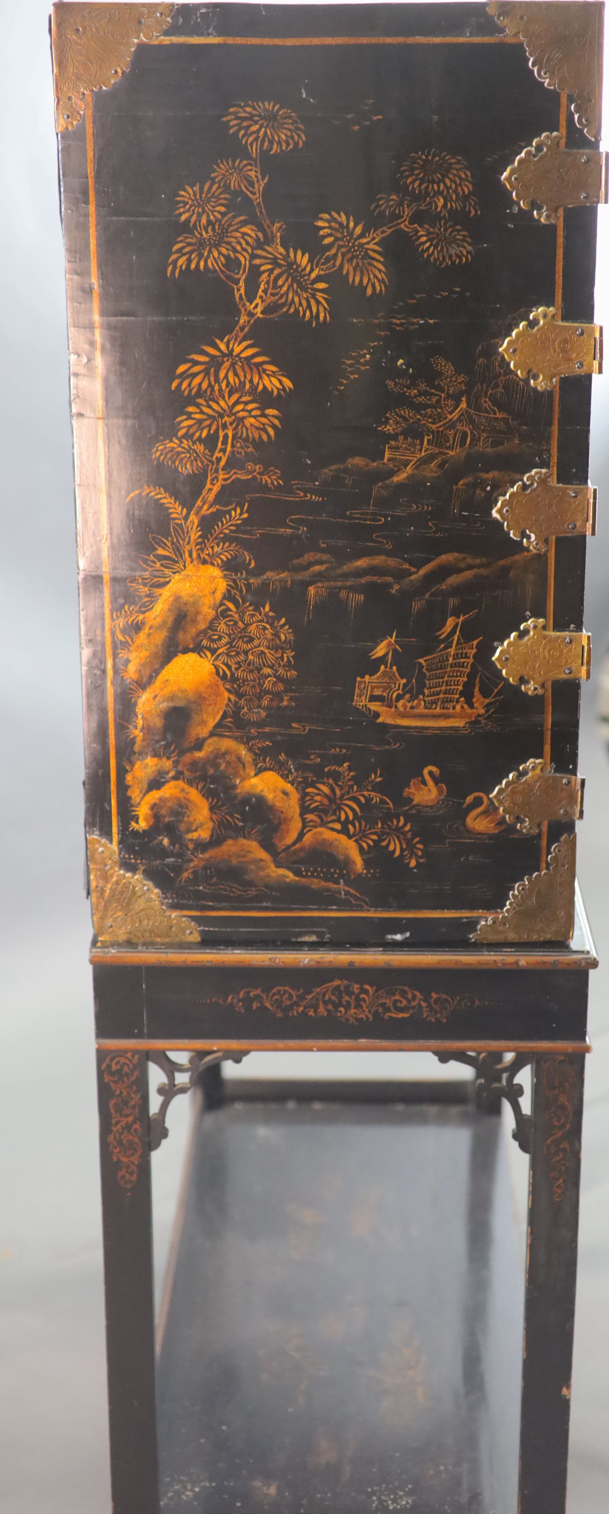 A late 17th century japanned cabinet on later stand W. 3ft. 1in. D. 1ft 4.5in. H. 2ft. 6in. Height overall 6ft 3in.